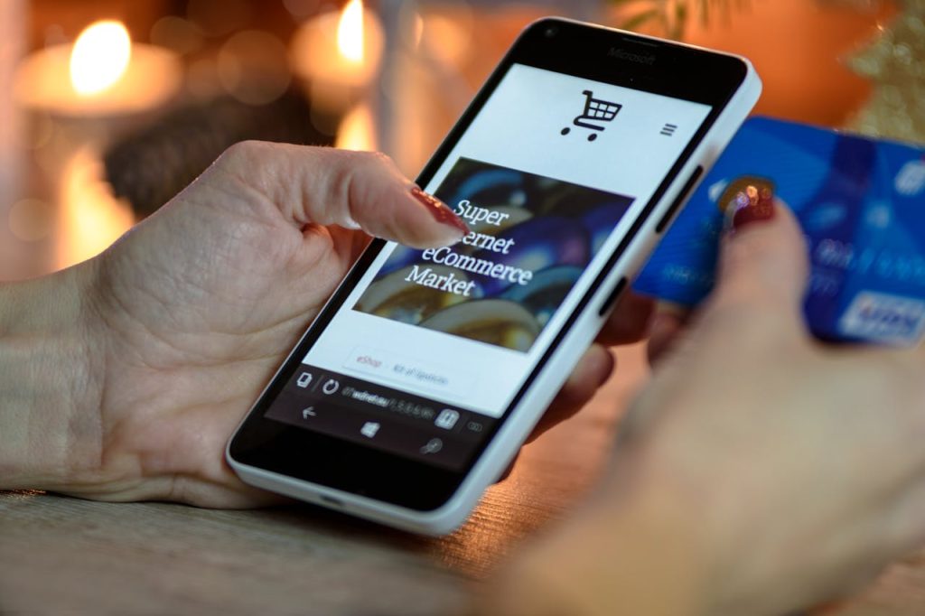 pexels-photo-230544 Person Using Black And White Smartphone and Holding Blue Card